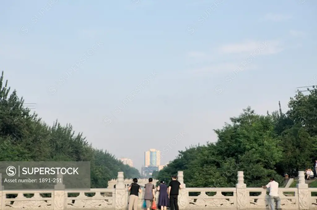 Tourists looking at city view from a bridge, Xi'an, Shaanxi Province, China