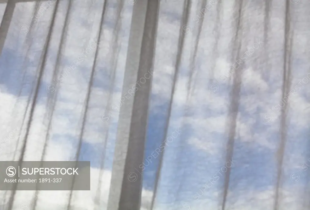 Clouds viewed through the curtain on a temple window, Tibet,