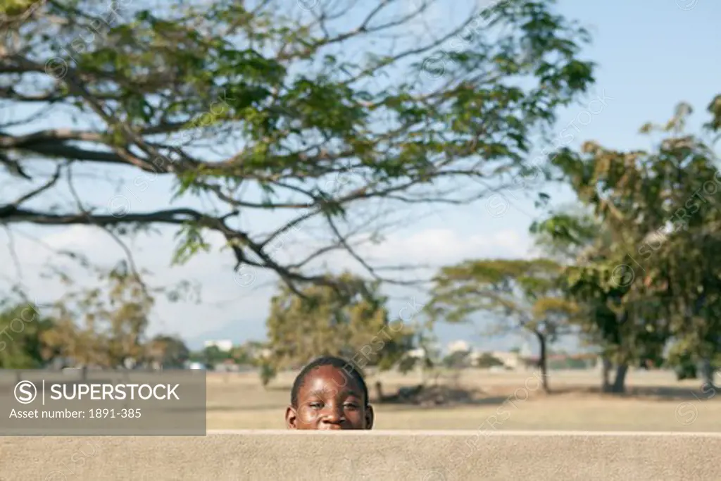 Schoolboy playing in a park, Jamaica