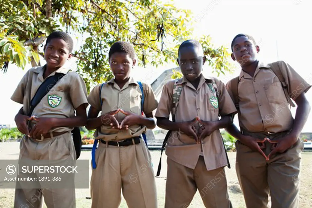 Four teenage boys making finger frames, Jamaica