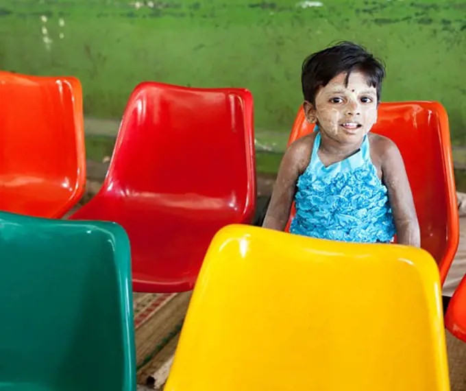 Girl sitting on a chair, Myanmar