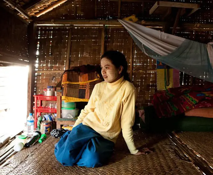 Woman sitting in a house, Myanmar