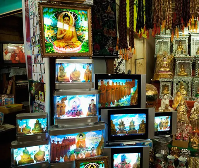 Statues and picture frames of Buddha's at a market stall, Myanmar