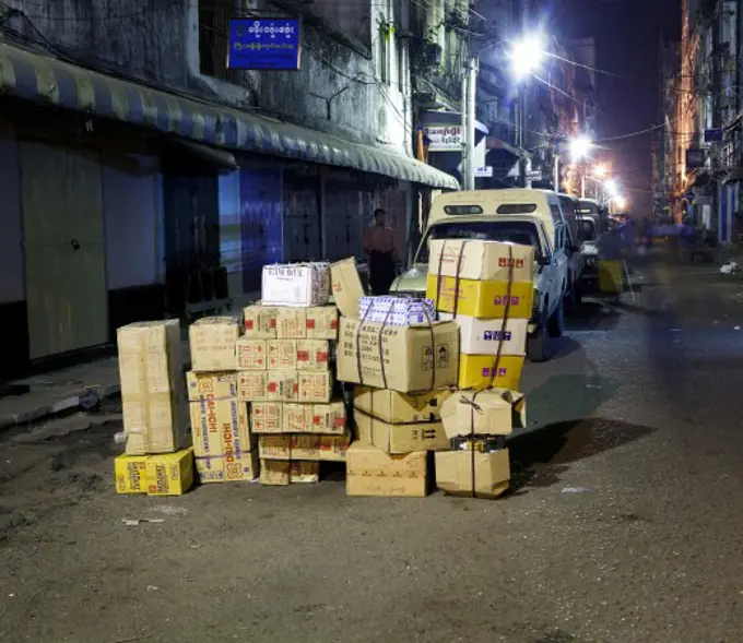 Stack of cardboard boxes in a street, Myanmar