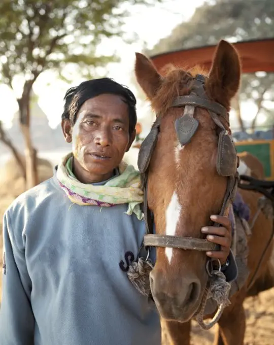 Man standing with a horse, Myanmar