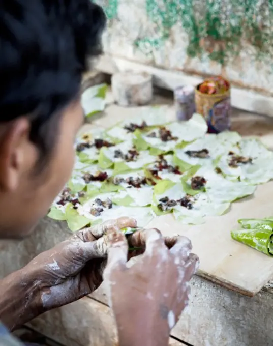 Man making betel nut, Myanmar