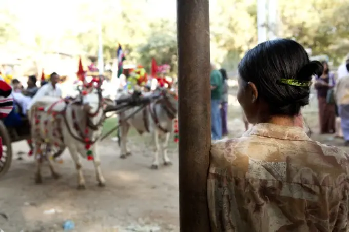 Woman watching a traditional ceremony, Myanmar