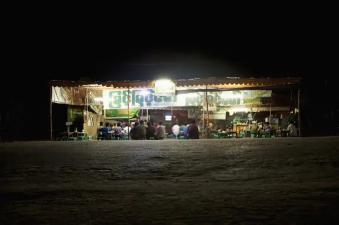 Tea shop lit up at night, Myanmar