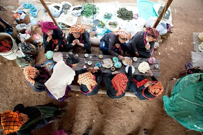 Group of people having lunch at a market, Myanmar