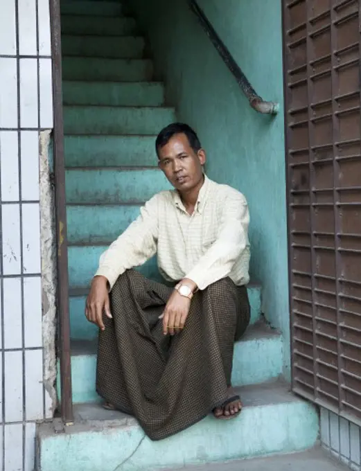 Man sitting on steps, Myanmar