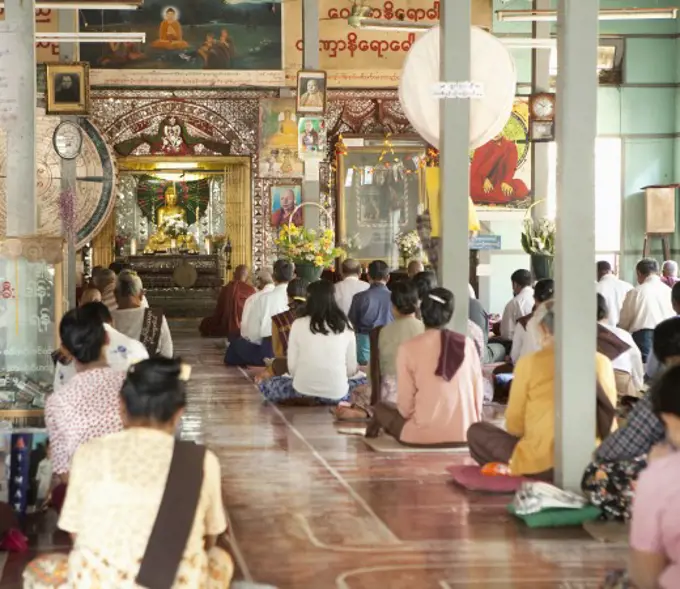 Group of people praying to Buddha, Myanmar