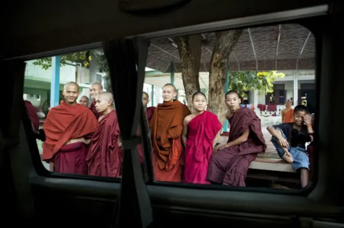 Monks viewed through the window of a car, Myanmar