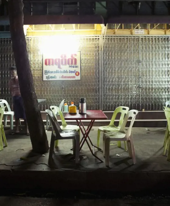 Empty chairs in a sidewalk cafe, Myanmar