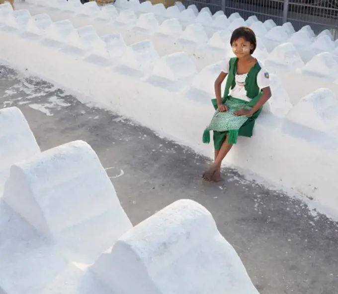 Girl sitting at a temple, Mandalay, Myanmar