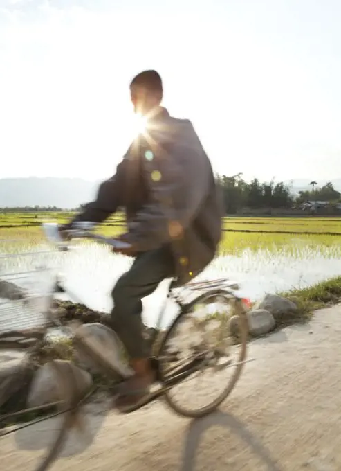 Myanmar, Man riding bicycle