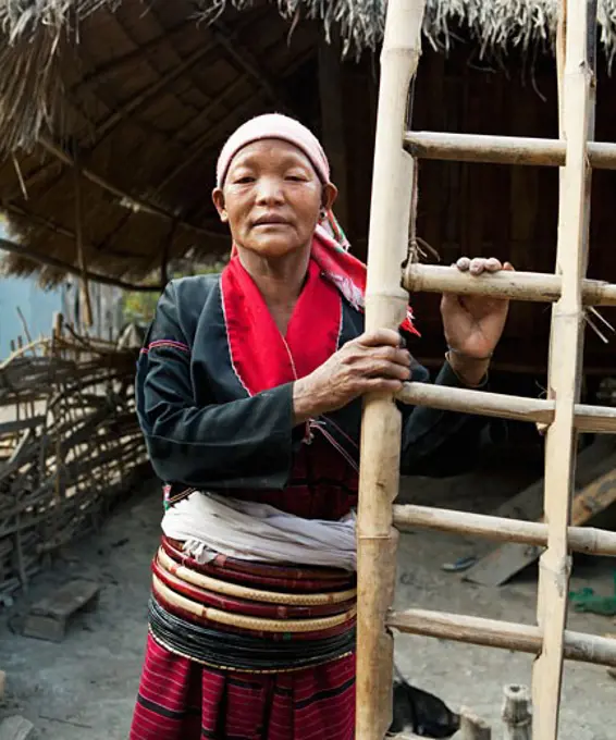 Ang woman standing with a ladder, Myanmar