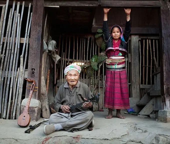 Ang women in a hut, Myanmar