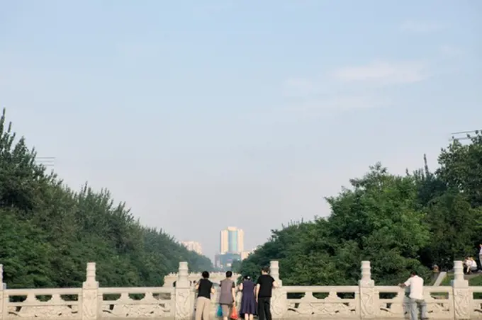 Tourists looking at city view from a bridge, Xi'an, Shaanxi Province, China