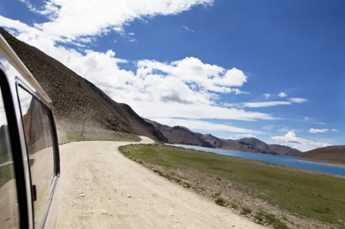 Car on a dirt road, Tibet,