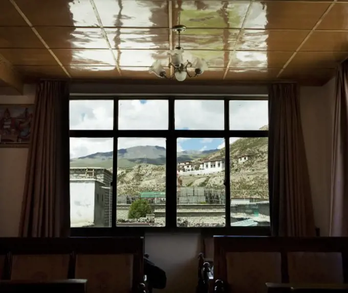 Temple viewed through the window of a dining hall, Tibet,