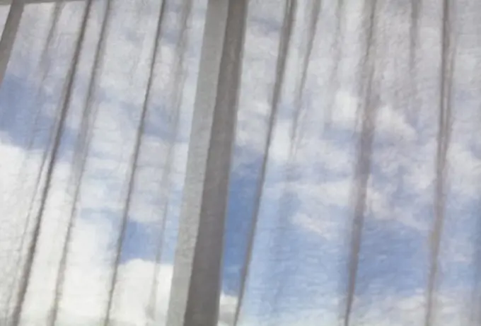 Clouds viewed through the curtain on a temple window, Tibet,