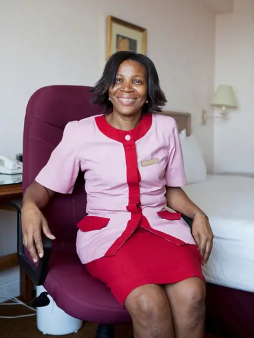 Hotel employee sitting on a chair in a hotel room, Jamaica