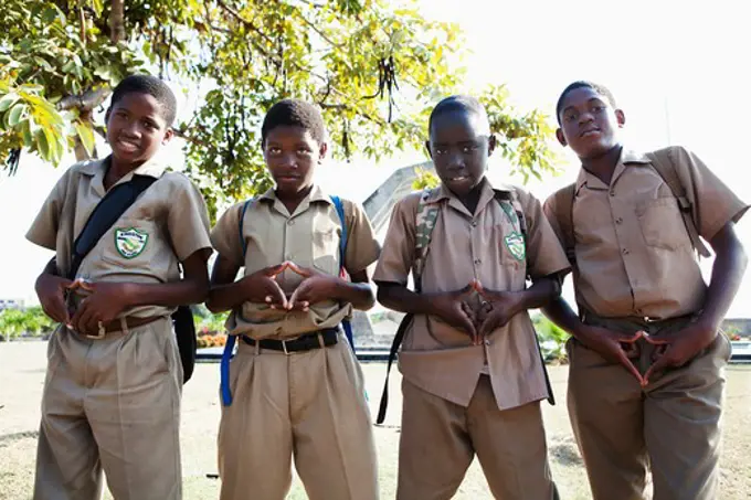 Four teenage boys making finger frames, Jamaica