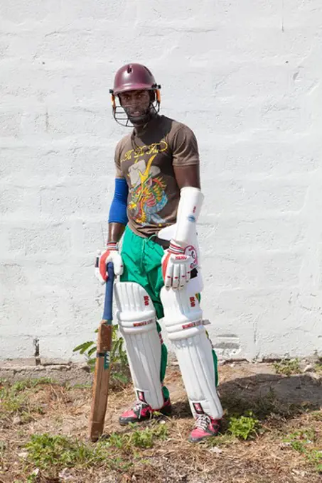 Cricket batsman standing in front of a wall, Jamaica