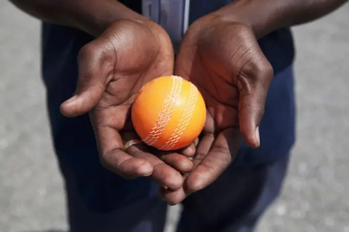 Close-up of a person's hands holding a cricket ball, Jamaica