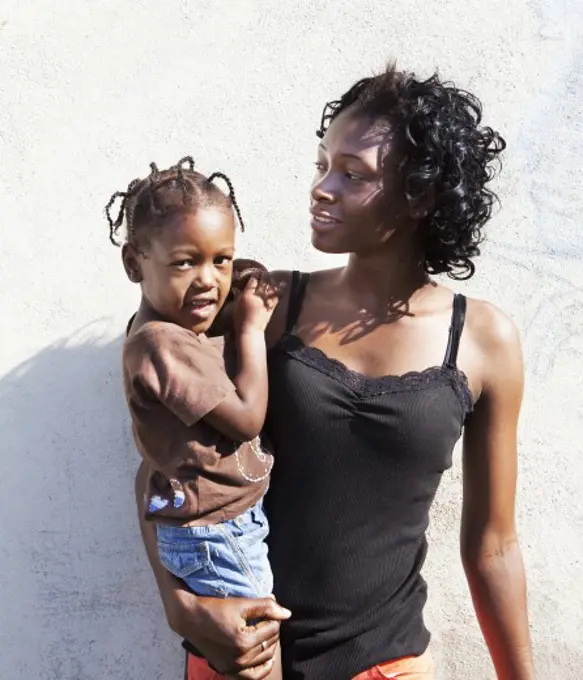 Woman carrying her daughter, Jamaica