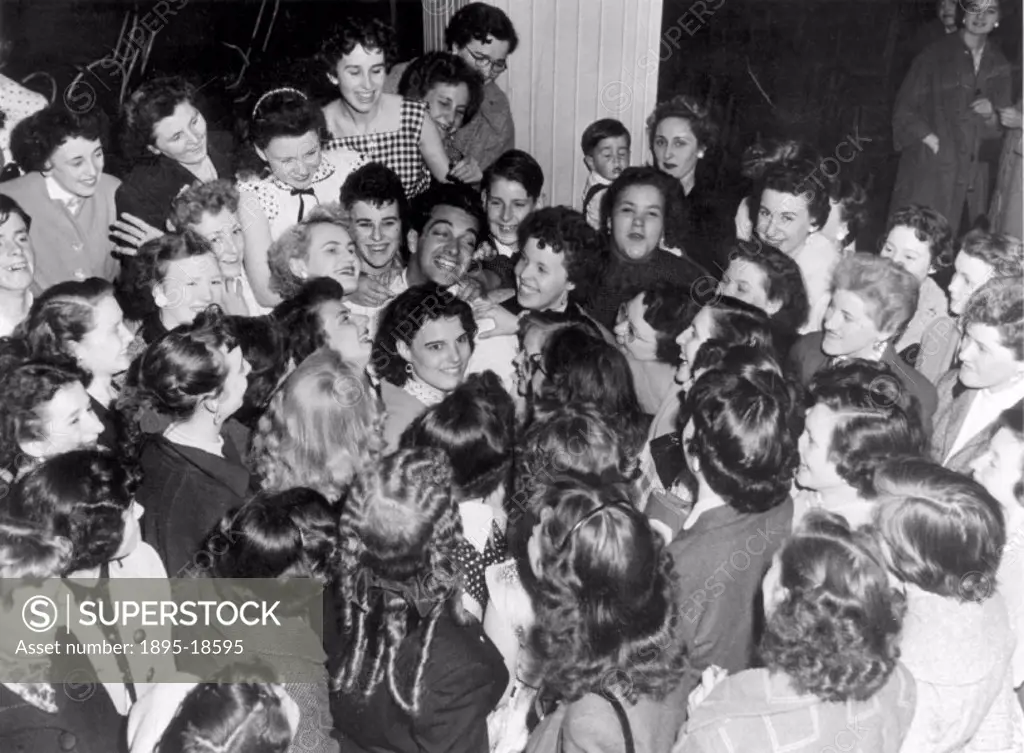 ´Frankie Vaughan, with his wife Stella, sings to the fans that are surrounding them.´ Photograph by Bishop Marshall.