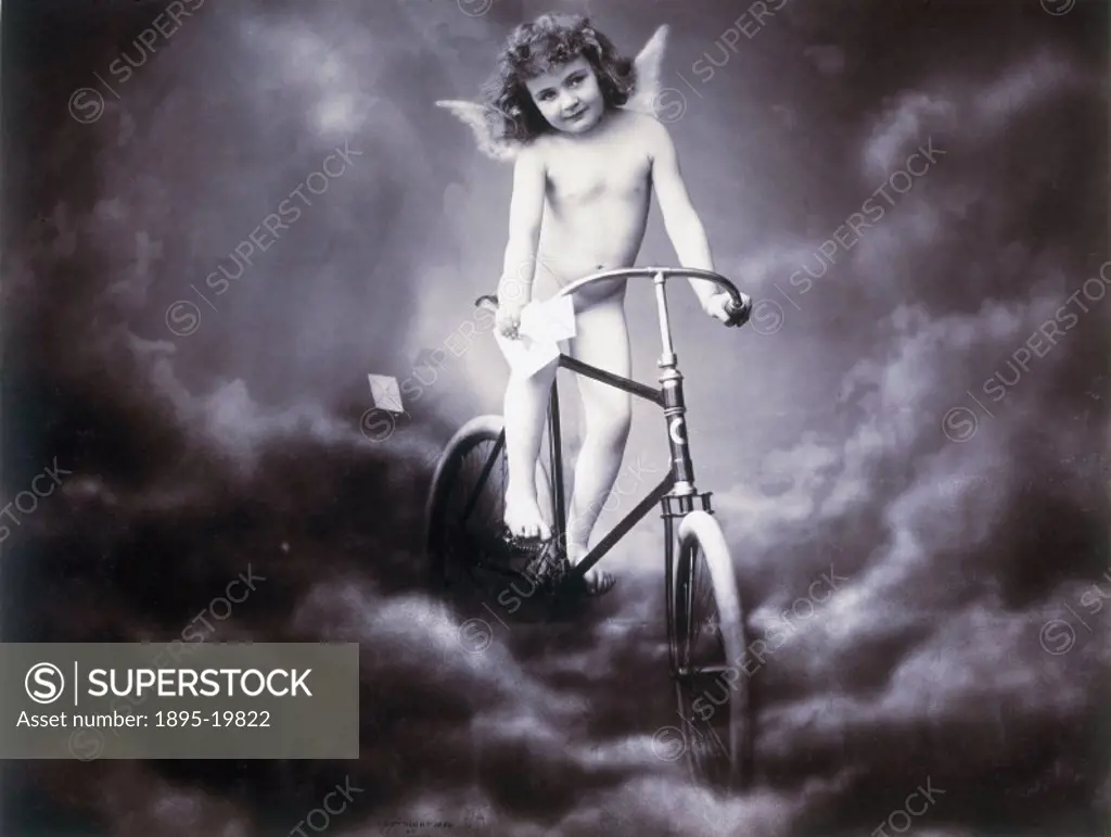 Nude girl posing as a cherub delivering letters by bicycle, 1896. Studio  portrait by James Arthur. - SuperStock