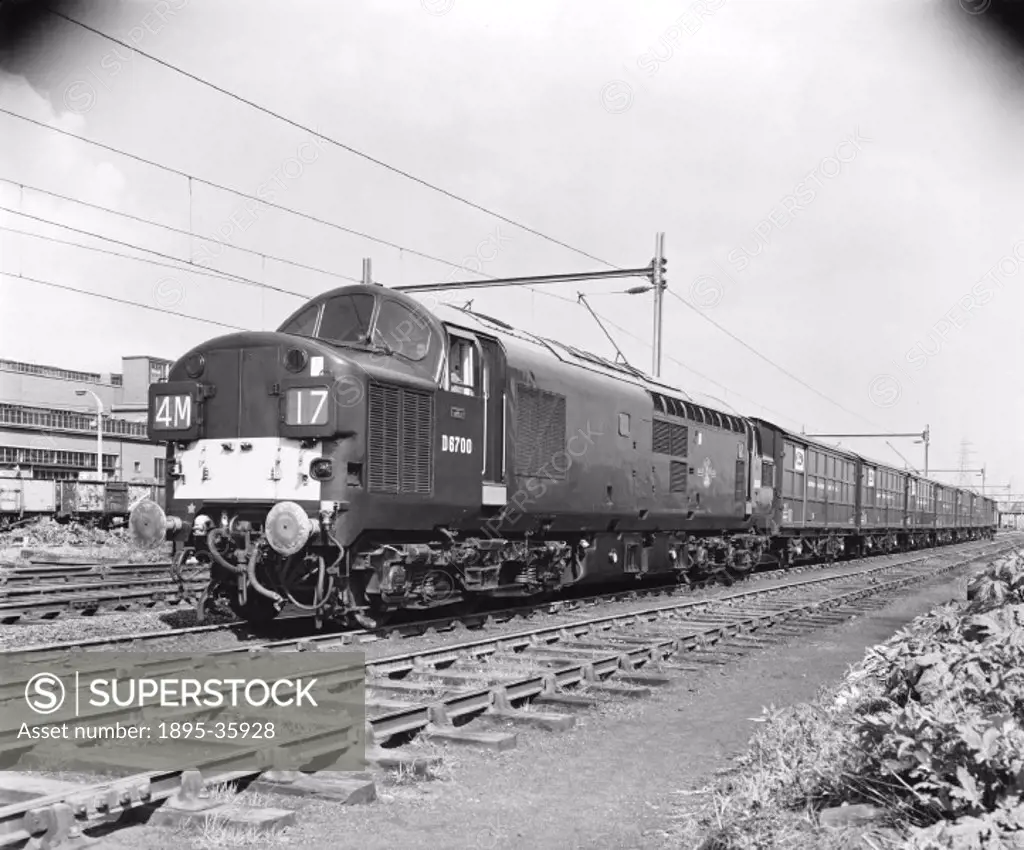 Freight train pulled by a diesel electric locomotive number D6700, 9 May 1963. This train is carrying Ford cars from Dagenham to Halewood.   Industrie...