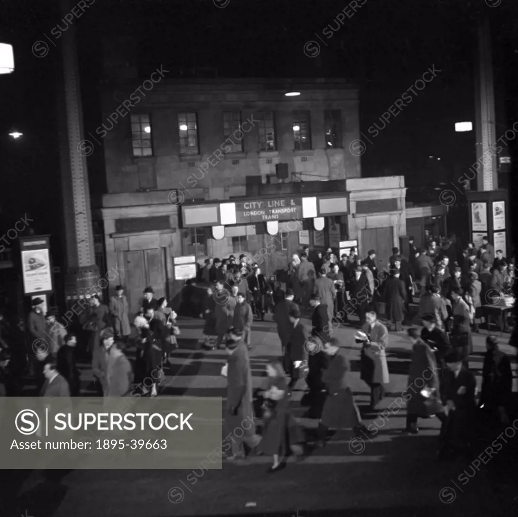 Passengers outside Euston station, 1951. They are passing the tube station for the City Line.  Euston station was about to be rebuilt at this time. In...