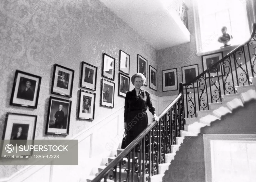 The Prime Minister on the Grand Staircase which was built to a cantilever design with no visible supports. Framed portraits of every prime minister ar...