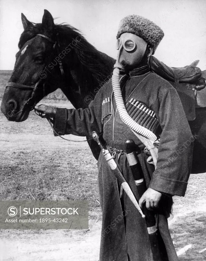 Cossack loses his glamour - anti-gas training spreads to Steppes. A gas-mask with hideous goggle “eyes” makes an incongruous contrast and takes some ...