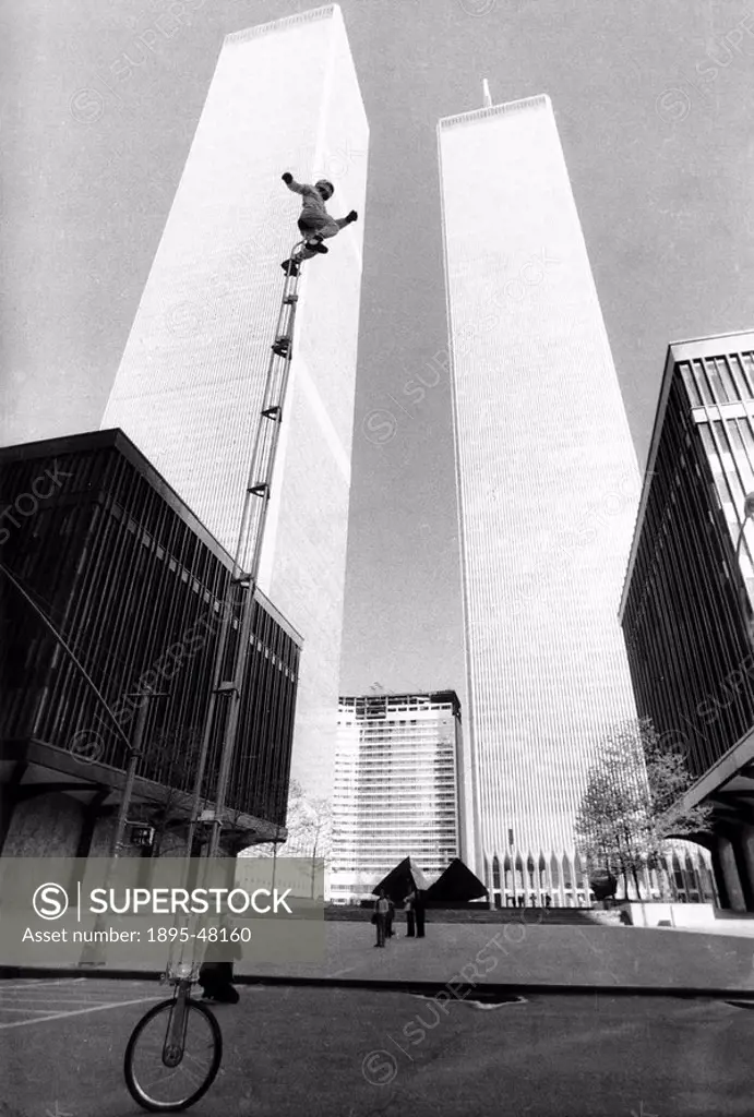 Unicycle rider near the World Trade Center, Manhattan, New York, c 1980s.Queens rider Denis Frisoli rides a very tall unicycle. In the background are ...