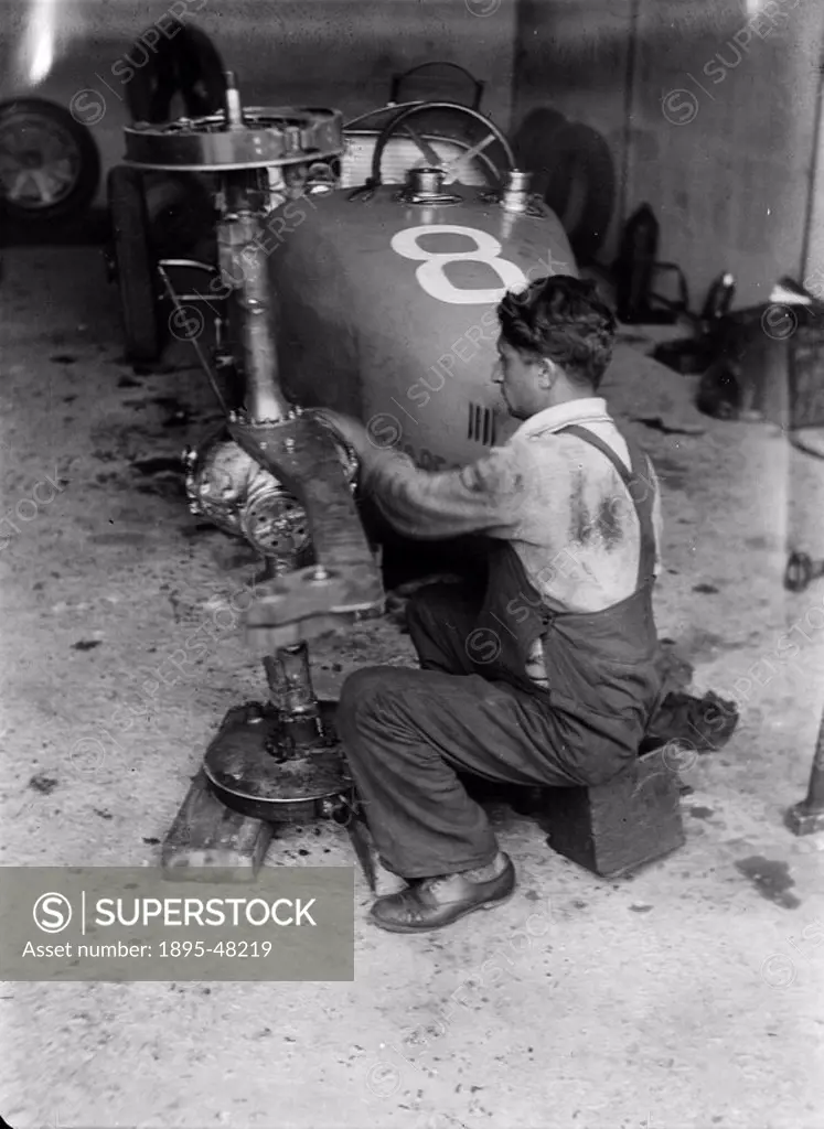 Mechanic working on a Bugatti racing car, Nurburgring, Germany, c 1931.Photograph by Zoltan Glass. A mechanic working on a Bugatti type 35, car No 8, ...