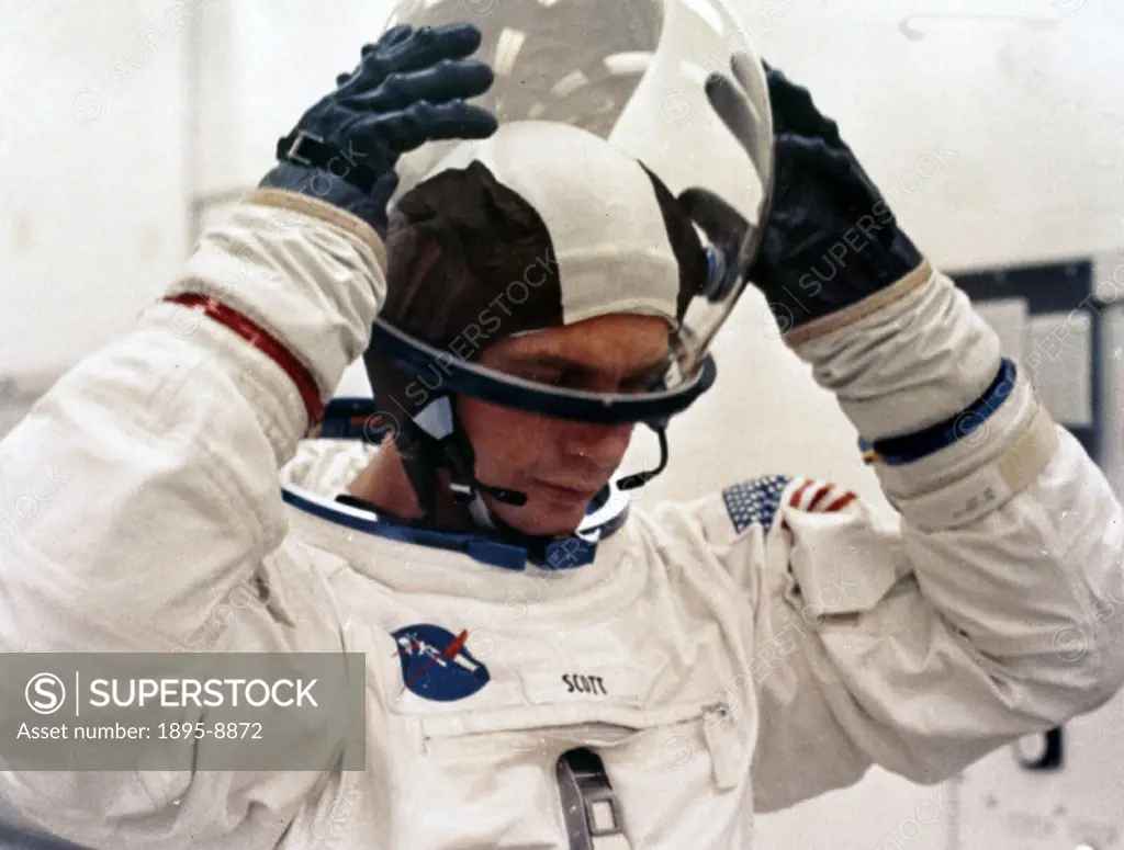 Seen here donning his spacesuit helmet, Scott was the Command Module pilot on the mission. He also flew in space on Gemini 8 and became the seventh ma...