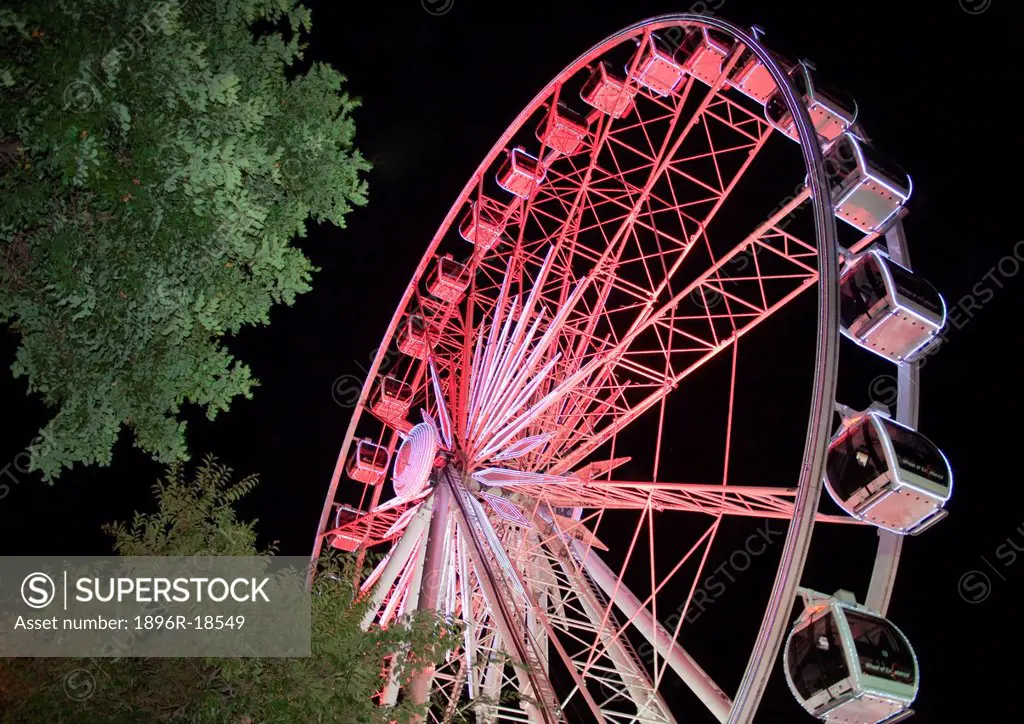 A Ferris Wheel operating at the Victoria and Albert Waterfront at night.