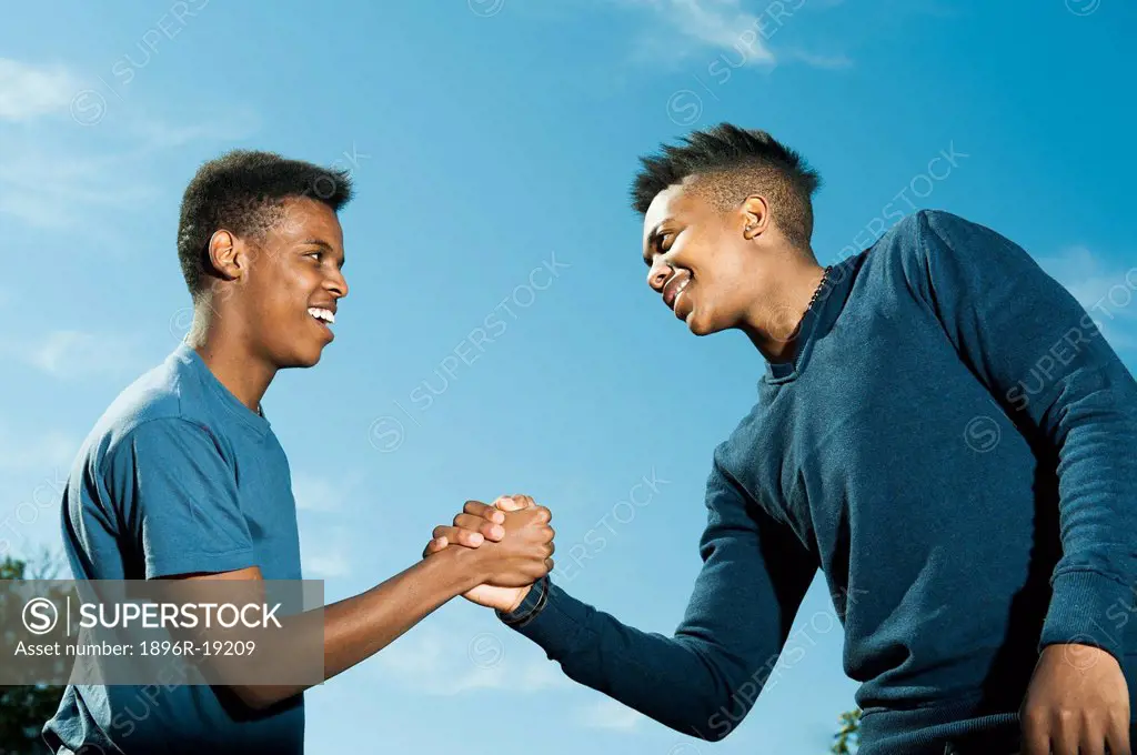 Two young men greeting using traditional african handshake, Johannesburg, South Africa