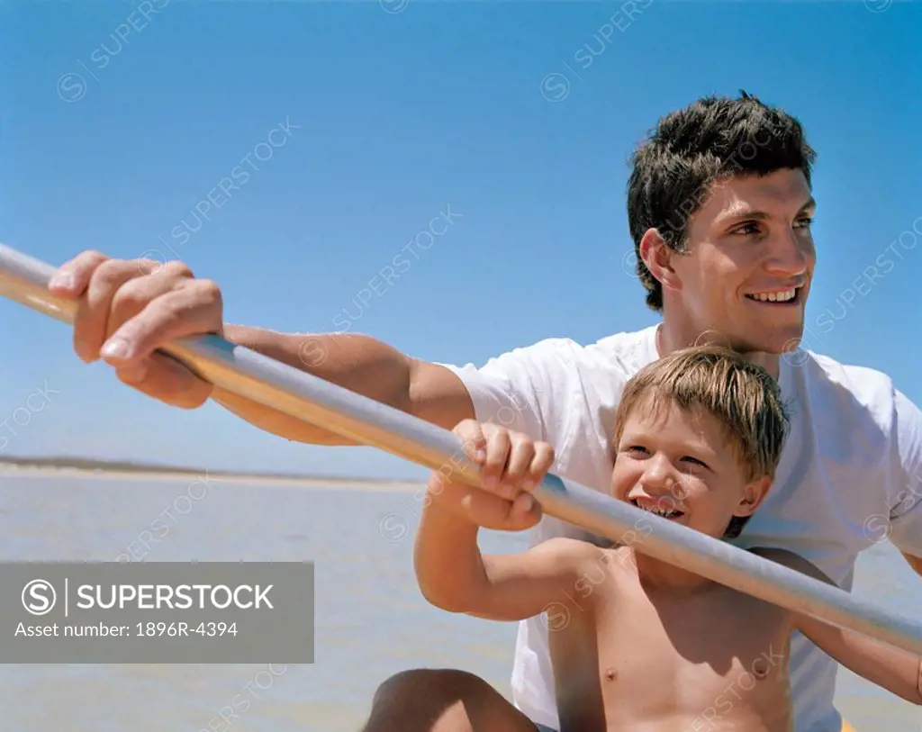 Young Boy in a Canoe with his Father  Cape Town, Western Cape Province, South Africa