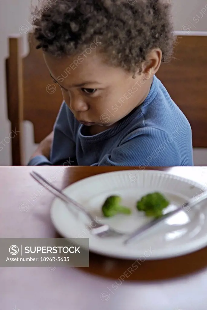 Young boy refusing to eat broccoli, Cape Town, Western Cape Province, South Africa