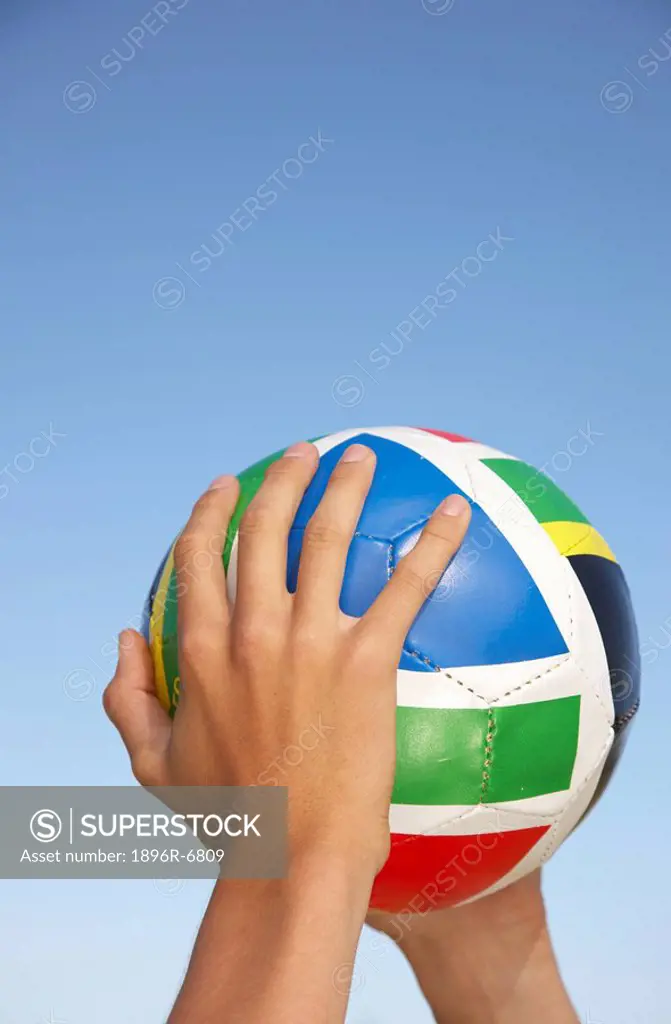 Close up of hands holding soccer ball with South African colours. Cape ...