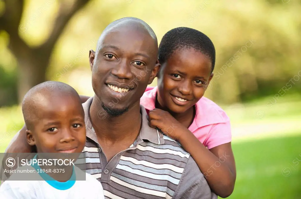 Portrait of father with children 4_8 outdoors, Johannesburg, Gauteng Province, South Africa