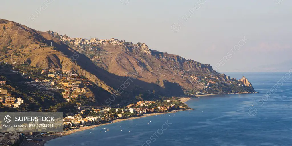 Panoramic photo of Letojanni Beach and Mazzeo Beach and the Ionian Sea, part of the Mediterranean Sea, seen from Taormina at sunset, East Coast of Sicily, Italy, Europe