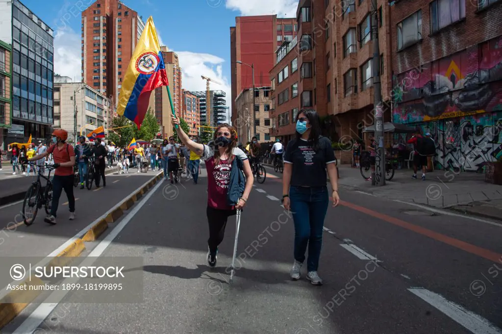 A handicapped woman without a leg, protests with a colombian flag in Bogota, Colombia on May 9 2021, as peaceful demonstrarions against police brutality had left at least 30 dead in the 12 days of Demonstrations in Colombia, as LGTB+ and Transgender community members participated in the protest.