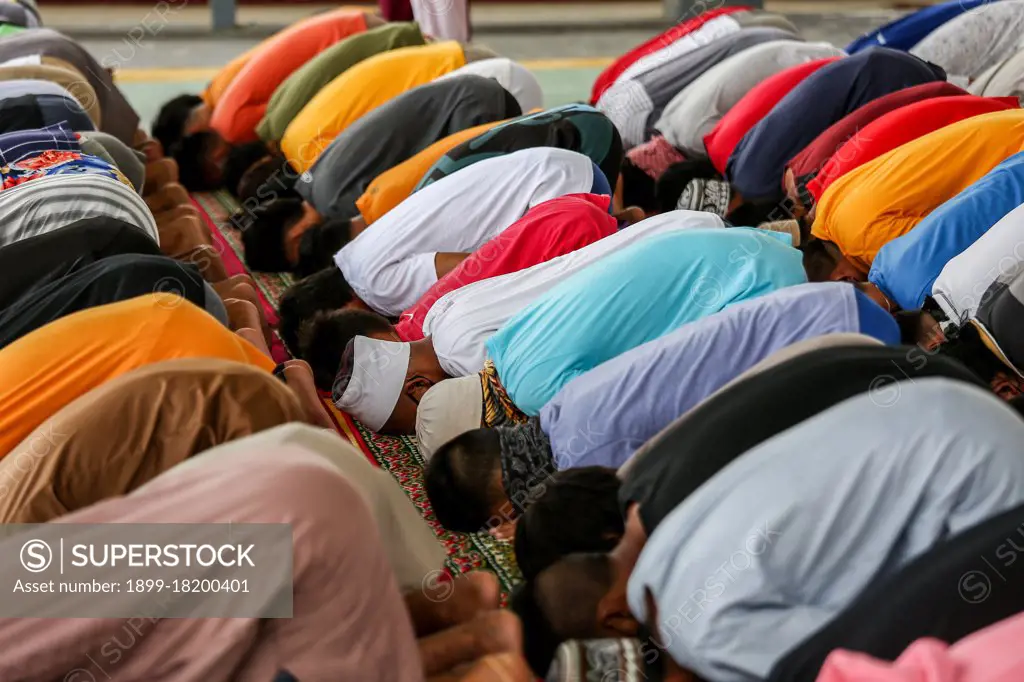 Filipino Muslims wearing protective masks as a precaution against the coronavirus outbreak gather as they attend a midday prayer in observance of Ramadan inside a Muslim community in Marikina city, Philippines.