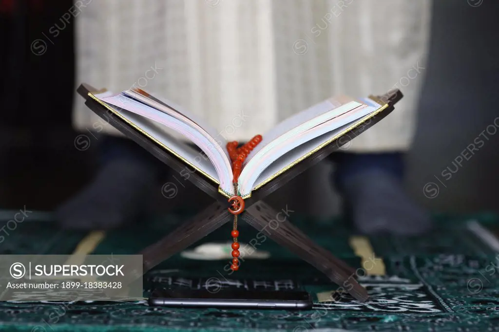 Muslim man pray at home during Ramadan. France. (Photo by: Fred de Noyelle/Godong/UIG)