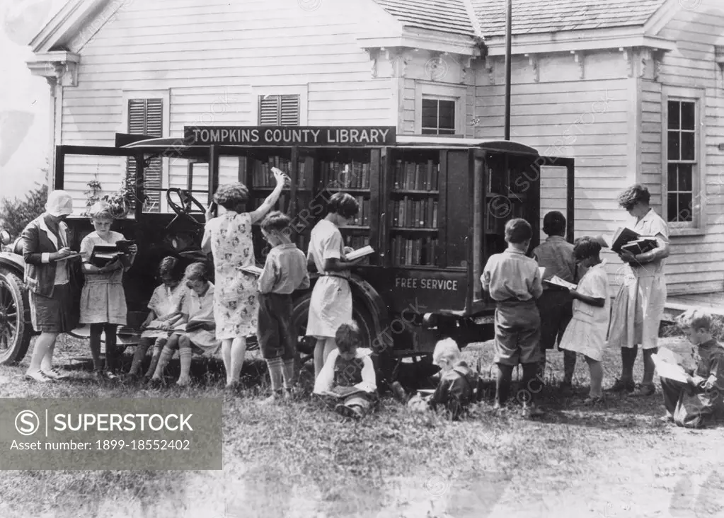 Rural schoolchildren crowd around a traveling book auto as they choose reading material, Tompkins County, NY, 1930. (Photo by G W  Ackerman/United States Department of Agriculture/GG Vintage Images)